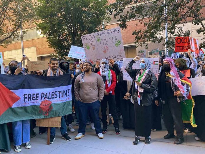 shutterstock_2374681249 B. J. Daniels and Eugene Sims among protesters holding signs at a pro-Palestine rally