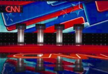 GOP Candidate Goes to Town on El-Sayed During Debate Debate stage with four podiums and colorful star backdrop
