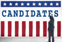 Man in suit writing on wall with word candidates and patriotic design