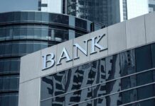 Bank building facade with large sign and glass windows