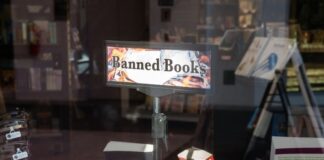 Banned books display in a bookstore window.