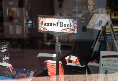 Banned books display in a bookstore window.