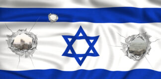 Israeli flag with bullet holes, cityscape visible through holes.