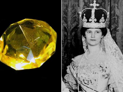 A yellow gemstone alongside a historical portrait of a woman in royal attire with a crown