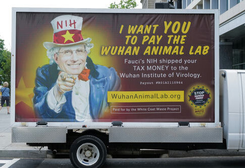 A van with an anti-NIH billboard featuring Anthony Fauci.