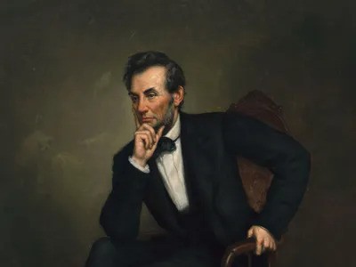 Portrait of Abraham Lincoln seated, deep in thought, wearing a black suit and bow tie
