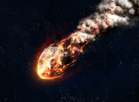 A fiery meteor streaking through the dark night sky
