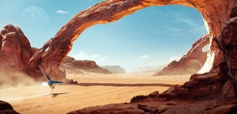 A blue bird flying through a desert landscape with a large natural arch and distant mountains
