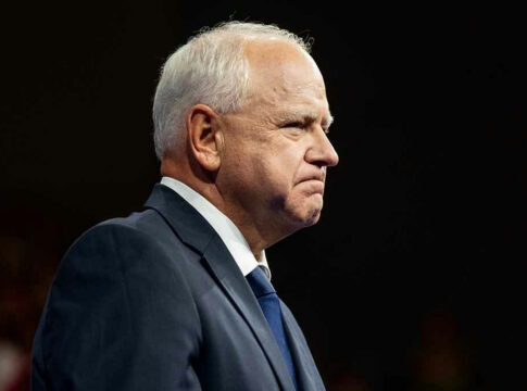 Elderly man in a suit looking determined.