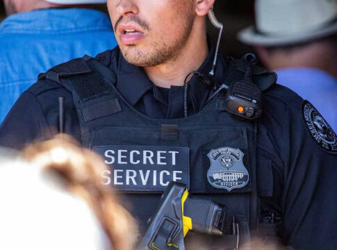 Secret Service officer wearing tactical gear and radio.