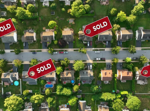Aerial view of neighborhood with Sold signs on houses.