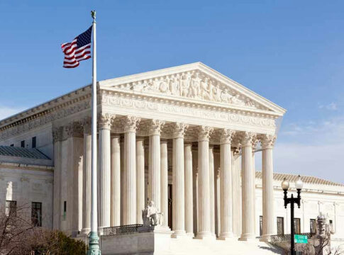 United States Supreme Court building with American flag.