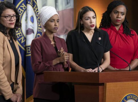 Four women politicians speaking at a press conference