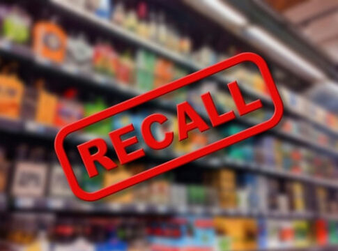 Recall text overlay on blurred store shelves background.