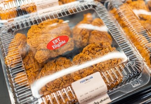 Packaged fried chicken in a grocery store with EBT eligibility label