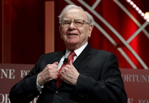 A distinguished man in a suit speaking at a conference