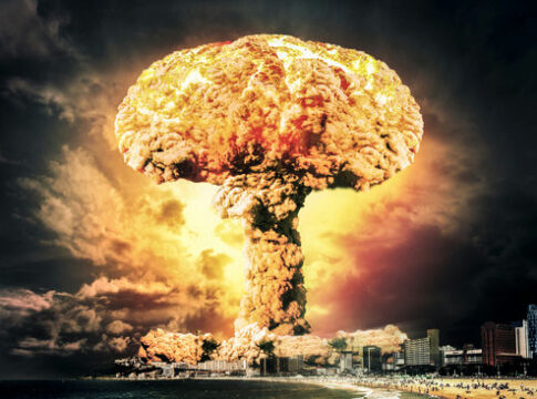 Massive mushroom cloud over a coastal city skyline