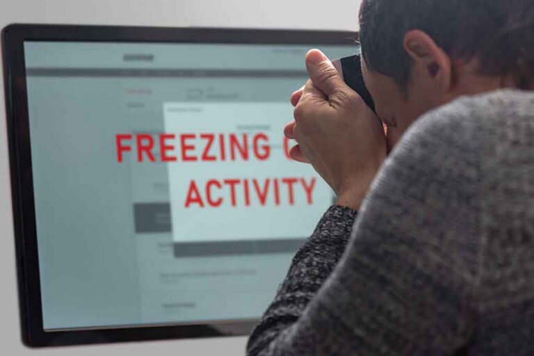 Person photographing computer screen with warning message
